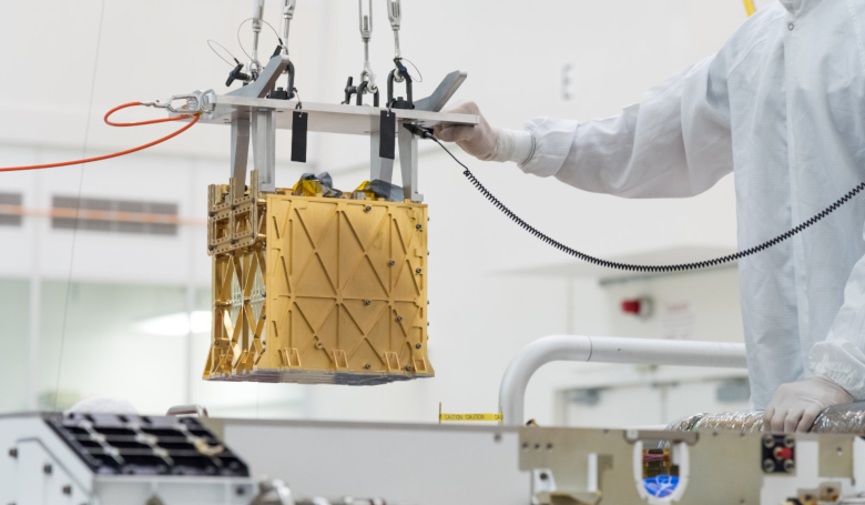 Technicians at NASA's Jet Propulsion Laboratory lower the Mars Oxygen In-Situ Resource Utilisation Experiment (MOXIE) instrument into the belly of the Perseverance rover. Image: NASA/JPL-Caltech