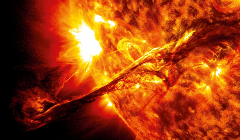 A coronal mass ejection caused by a huge electromagnetic explosion on the surface of the Sun. Such explosions send out billions of protons and electrons, in a superheated ball of plasma, into the solar system.