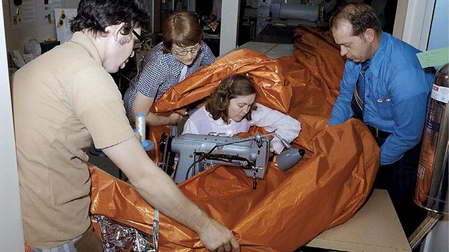 NASA seamstress Aylene Baker pictured stitching part of a replacement heat shield for Skylab in 1973