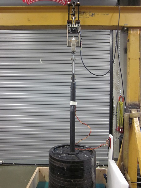Test setup for molten rod release mechanism (with up to 30 x 20 kg stacked weight plates from athletics department)