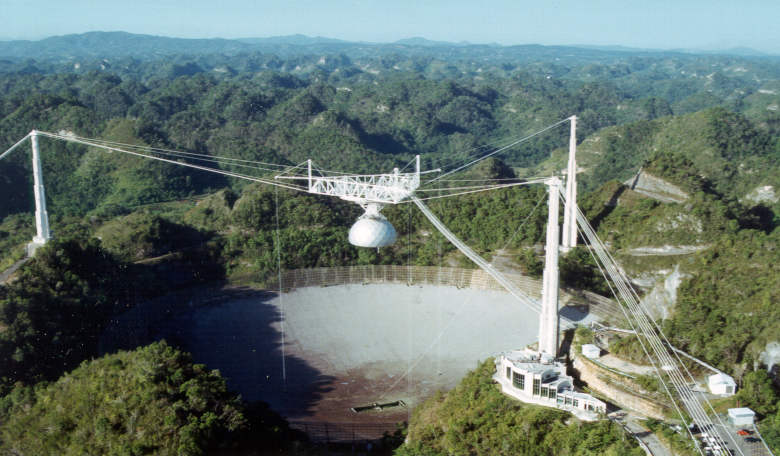 The famous Arecibo Observatory perched in the Puerto Rican hills faces imminent deconstruction amid safety fears over the crumbling structure. Image: NSF