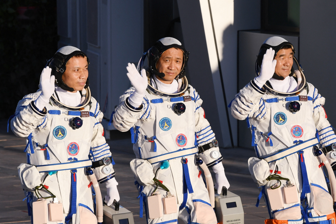 Astronauts Tang Hongbo, left, Nie Haisheng, centre, and Liu Boming wave during a departure ceremony before boarding the Shenzhou-12 spacecraft at the Jiuquan Satellite Launch Centre in northwest China. Image: Greg Baker/AFP