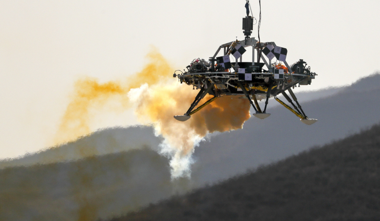 A lander is lifted during a test of hovering, obstacle avoidance and deceleration capabilities at a facility in Huailai in China's Hebei province,  14 Nov, 2019. Image: AP Photo/Andy Wong