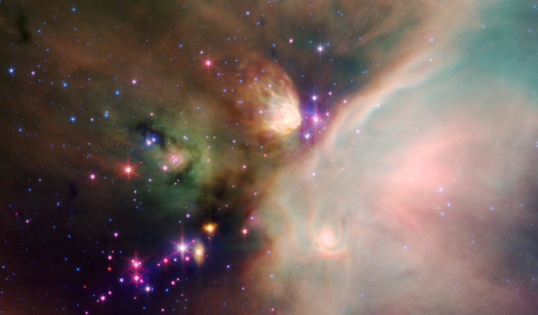 Cosmic dust clouds and embedded newborn stars glow at infrared wavelengths in this tantalising false-colour view of the Ophiuchus cloud cluster from the Spitzer Space Telescope. Image: NASA JPL-Caltech, Harvard-Smithsonian CfA