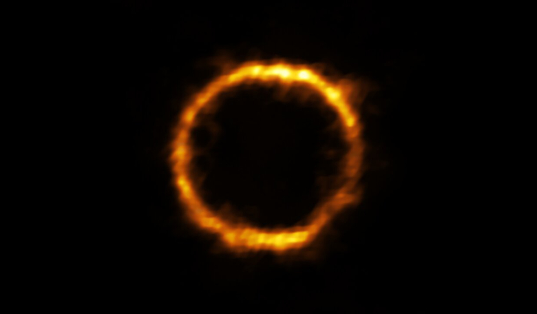 The galaxy, SPT0418-47, is gravitationally lensed by a nearby galaxy, appearing in the sky as a near-perfect ring of light. Image: ALMA (ESO/NAOJ/NRAO), Rizzo et al.