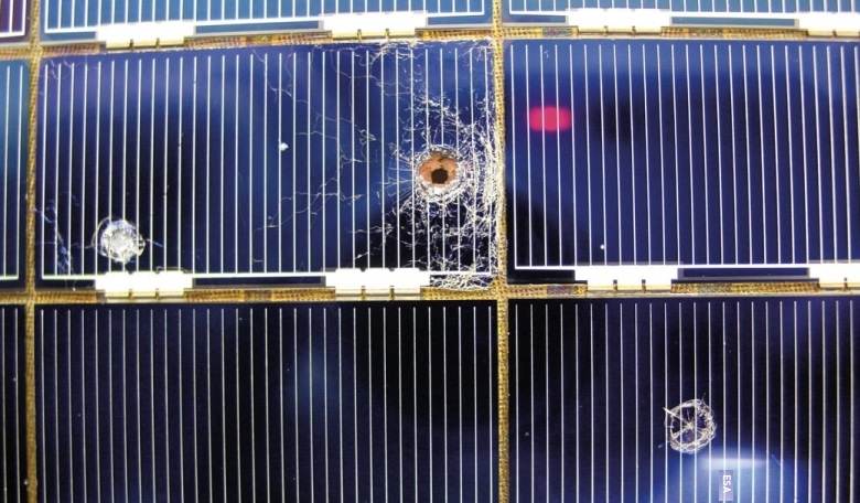 Solar cells removed during Hubble upgrades showing holes and craters from space debris impacts.