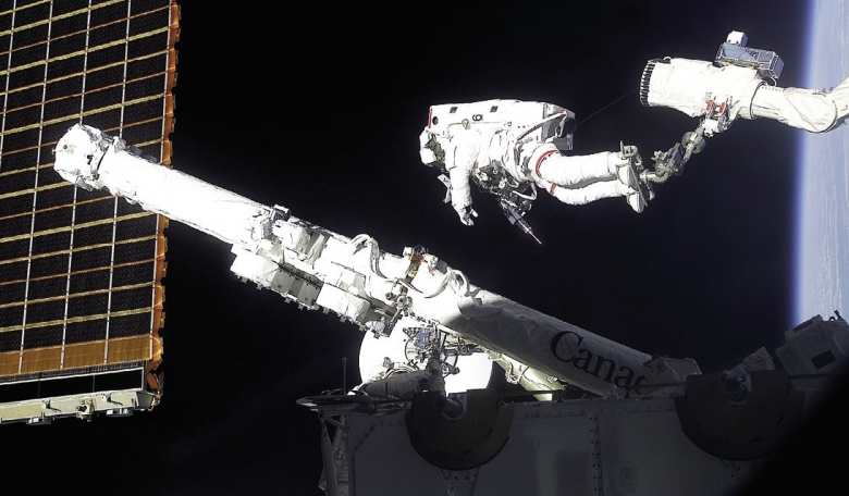 Chris Hadfield on the end of the Shuttle’s Canadarm, deploys Canadarm2 in April 2001.