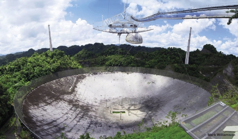 The Arecibo radio telescope showing the Gregorian dual-reflector feed and two of the three support towers.
