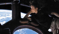 Astronaut Tracy Caldwell Dyson takes in the view of Earth from the ISS Cupola module.