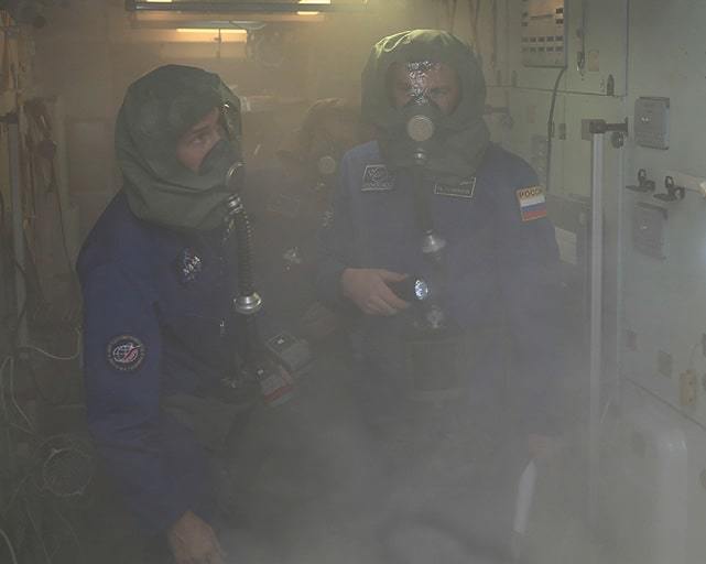 Crew simulation training for a fire event in an ISS module.