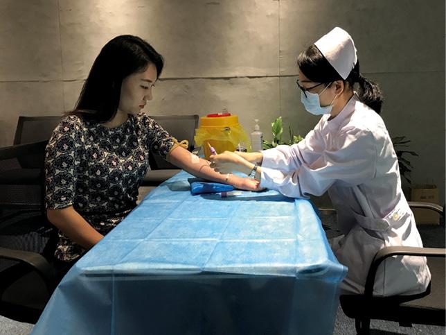 Li Bing giving a 5ml blood sample for DNA for the first launch of the project.