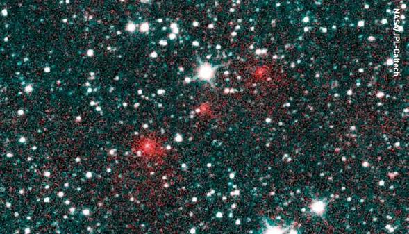 Comet C/2020 F3 NEOWISE appears as a trio of fuzzy red dots in this composite of several