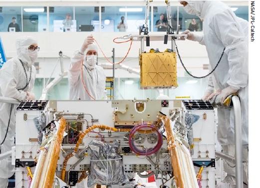 MOXIE is lowered into the chassis of NASA’s Perseverance rover in 2019.