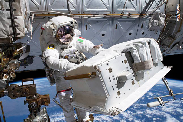 ESA Italian astronaut Luca Parmitano, attached to the Canadarm2 robotic arm