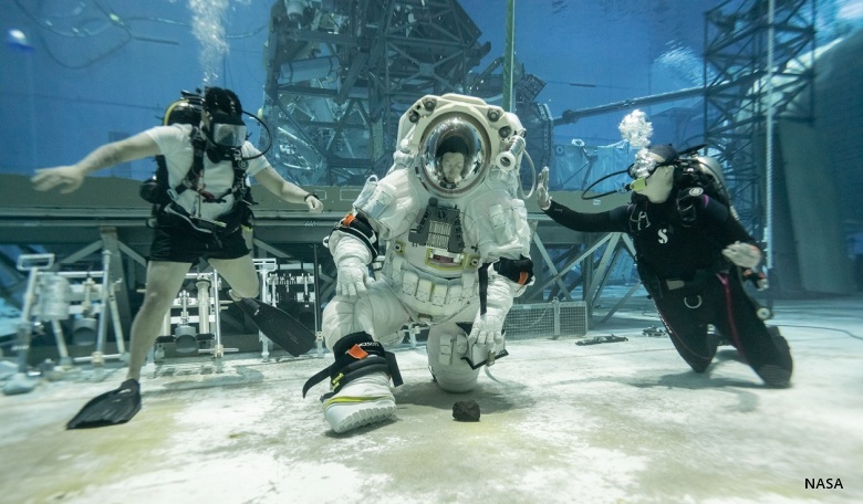 NASA astronaut Loral O’Hara kneels to pick up a rock while testing the mobility of Axiom Space’s lunar spacesuit. NASA and Axiom Space teams held the first dual spacesuit run at the Neutral Buoyancy Laboratory in Houston in September 2025 with astronauts Stan Love and Loral O’Hara. This was the final integration test in the pool, proving both the spacesuit and facility are prepped and ready for Artemis mission training.
