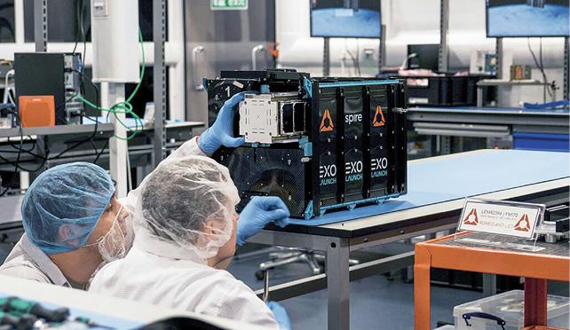Spire engineers in the firm’s Glasgow cleanroom.