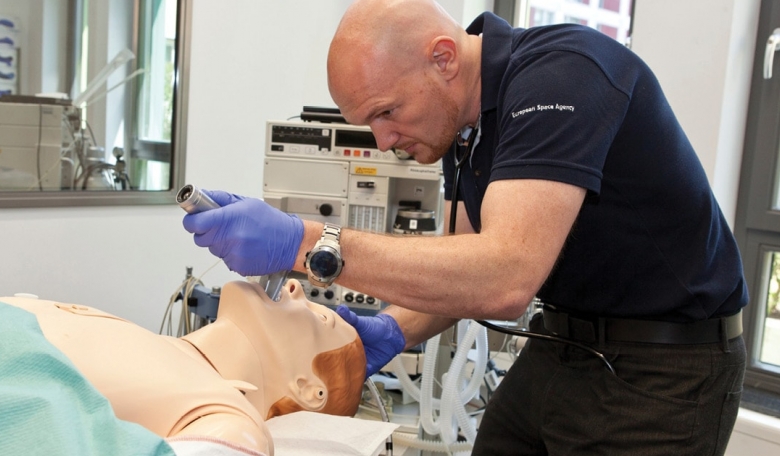 ESA astronaut Alexander Gerst practising his medical skills on a mannequin during pre-flight training.